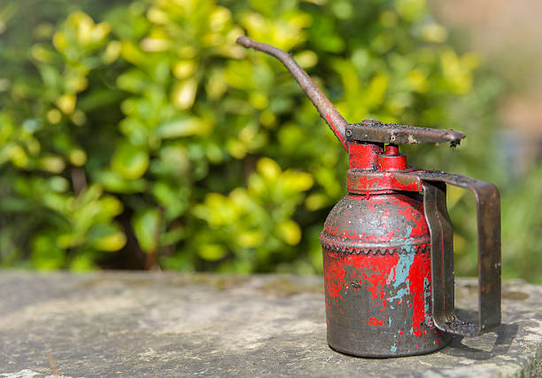 istock Old style oil can with spout and handle in red 474752616