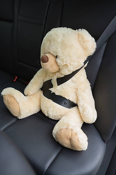 istock Teddy bear strapped in with seat belt 474753354