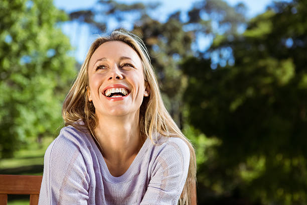 istock Pretty blonde relaxing in the park 474753630
