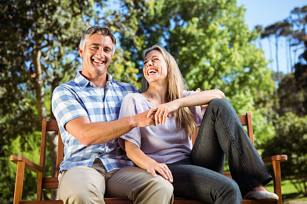 istock Couple relaxing in the park on bench 474753708