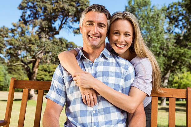 istock Couple relaxing in the park on bench 474753760