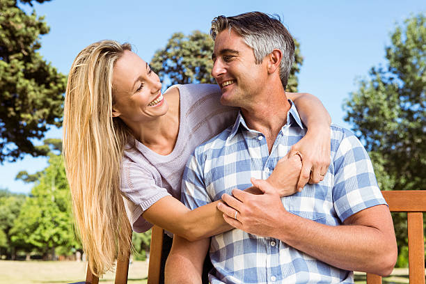 istock Couple relaxing in the park on bench 474753764