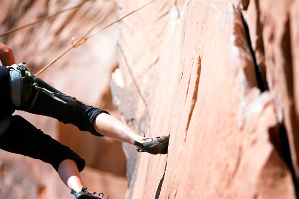 istock Young woman Climbing a Sandstone Cliff  Near Moab Utah 474754500