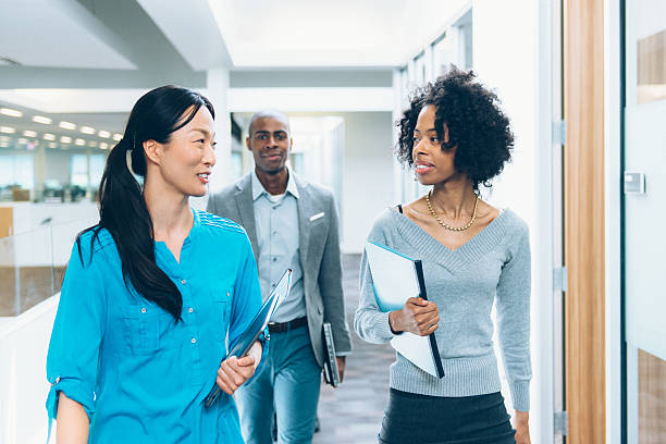 Multiracial Business Team Going to a Meeting Multiracial business team going to a meeting in modern office office cubicle photos stock pictures, royalty-free photos & images