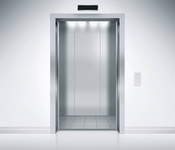 Elevator Doors Open An empty modern elevator or lift with metal doors that are open in building with lighting. lift stock pictures, royalty-free photos & images