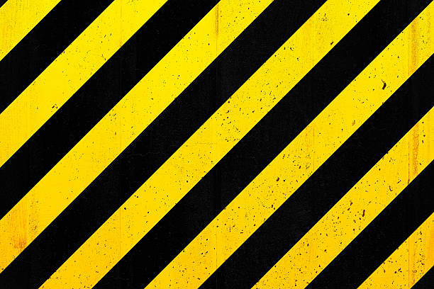 istock Concrete wall with black and yellow stripes 474759978
