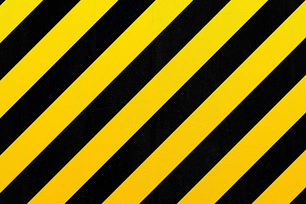 istock Concrete wall with black and yellow stripes 474759984