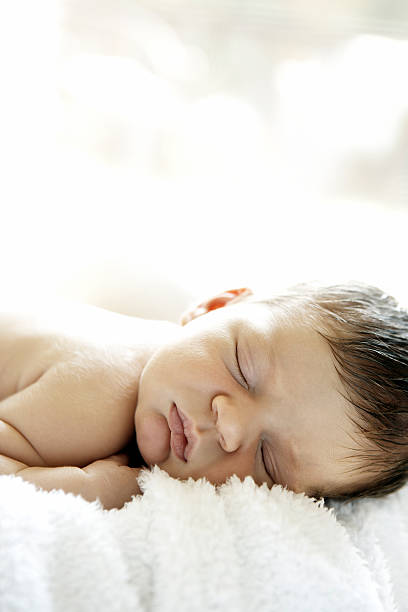 Sleeping newborn baby stock photo