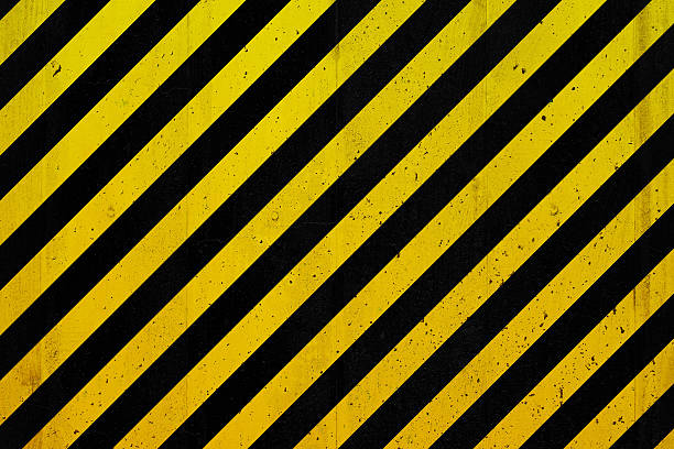 istock Concrete wall with black and yellow stripes 474764662