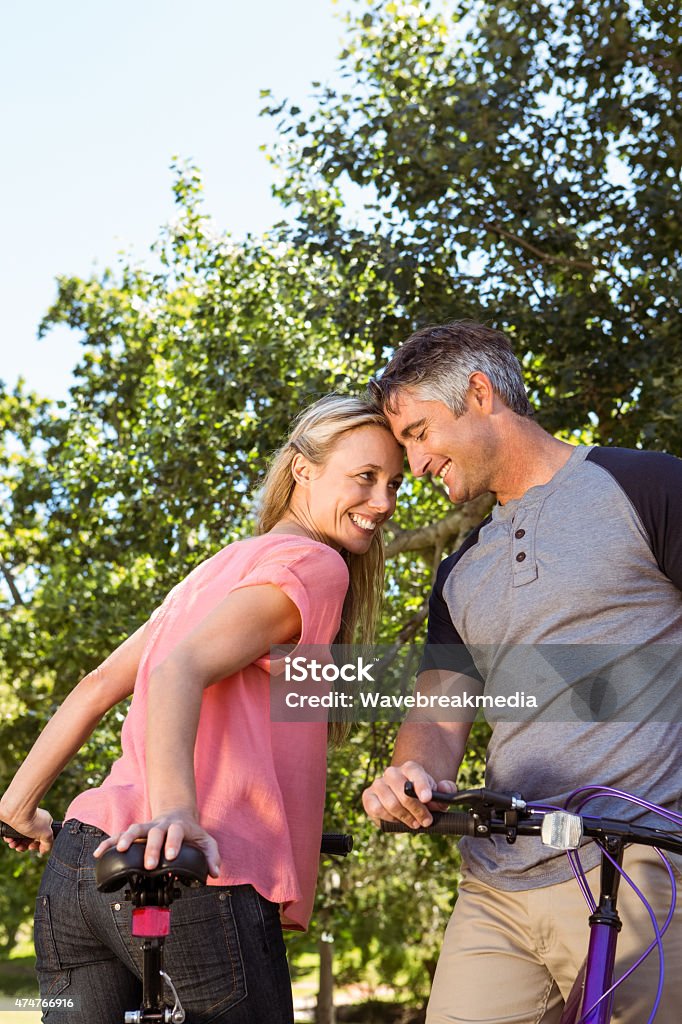 Happy couple on a bike ride Happy couple on a bike ride on a sunny day 2015 Stock Photo