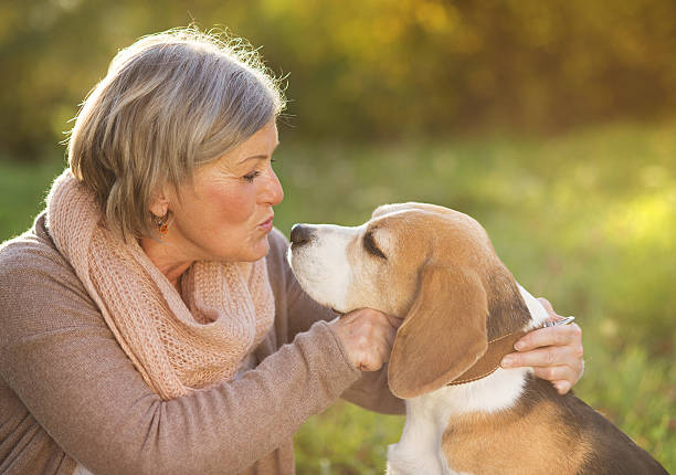 istock Active senior woman hugs dog 474776001