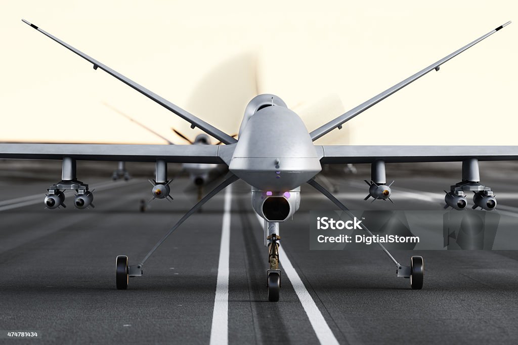 Military armed UAV drones preparing for takeoff on a runway. Military armed UAV drones preparing for takeoff on a runway. Photo realistic 3d model scene. Unmanned Aerial Vehicle Stock Photo