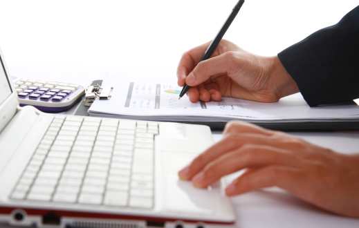 Close-up photo of a business woman analyzing financial data