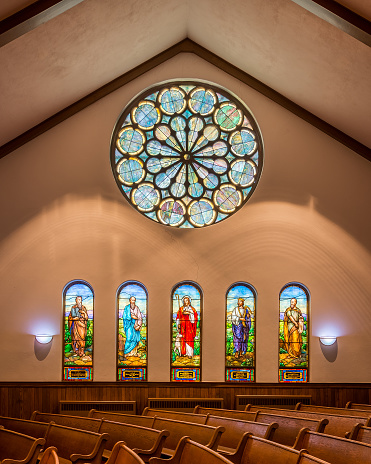 Holland, Michigan, USA - May 12, 2015: Five stained glass windows below rose window in the sanctuary of the Hope Church in Holland, Michigan