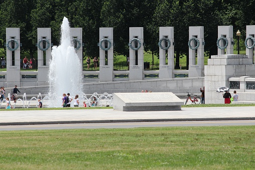 Washington, United States - June 13, 2013: People visit National World War II Memorial on June 13, 2013 in Washington. 18.9 million tourists visited capital of the United States in 2012.