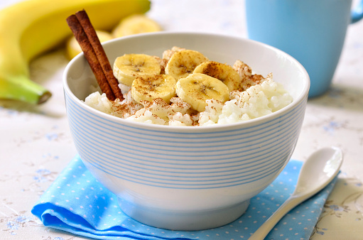 Milk rice porridge with banana,cinnamon and honey - healthy breakfast.