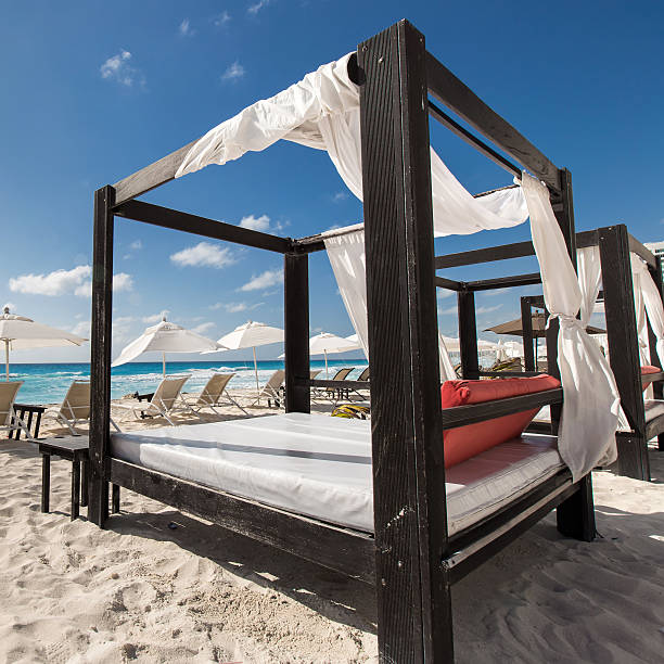 Luxury wooden lounge beds on caribbean beach