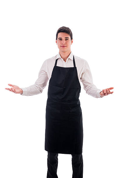 istock Young chef or waiter wearing black apron isolated 474791120