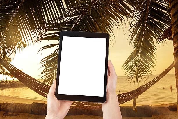 istock hands hold the tablet and holiday background 474794770