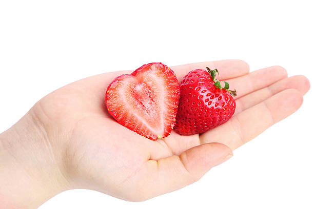 istock Beautiful hand with strawberry heart 474795472