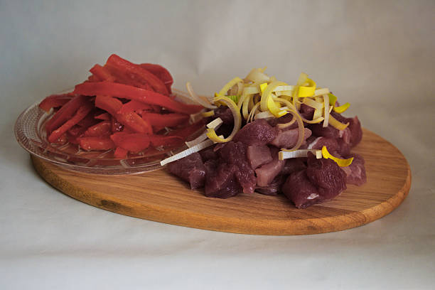 istock raw pork cubes with red pepper on wood 474798936
