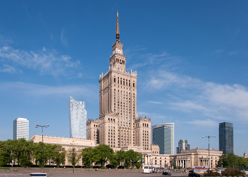 Warsaw city center with Palace of Culture and Science (PKiN),  a landmark and symbol of Stalinism and communism, and modern sky scrapers .