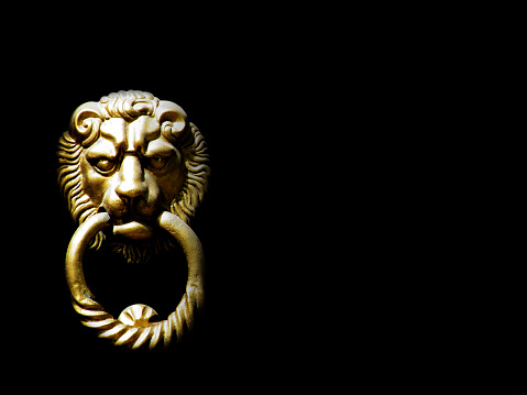 Lion's head door knocker on the black background isolated