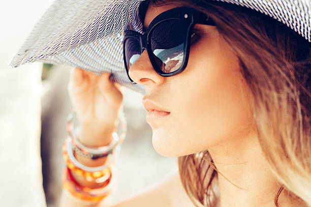 young summer girl wearing  hat  and sunglasses stock photo