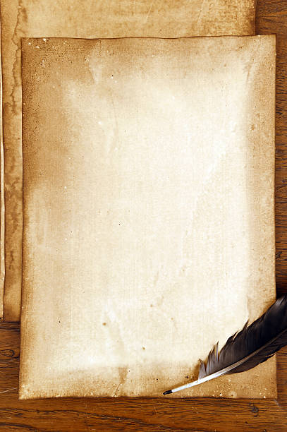 istock old paper with feather on brown wood texture 474804328