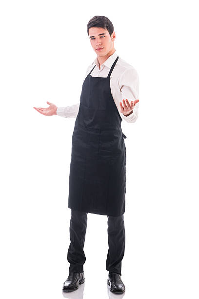 istock Young chef or waiter wearing black apron isolated 474804932