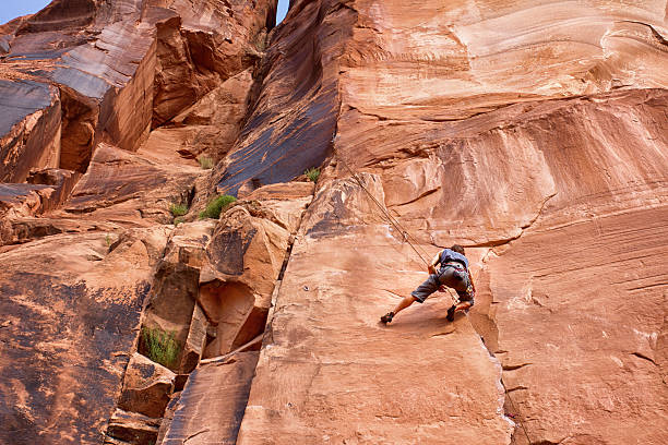 Young Caucasian Man Climbing a Rock Wall Near Moab