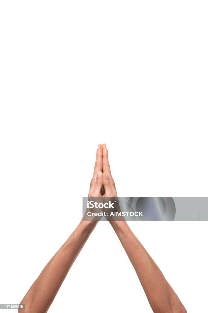 Hands praying Human hands praying. Isolated on white background. Vertical photo with copy space. 2015 Stock Photo