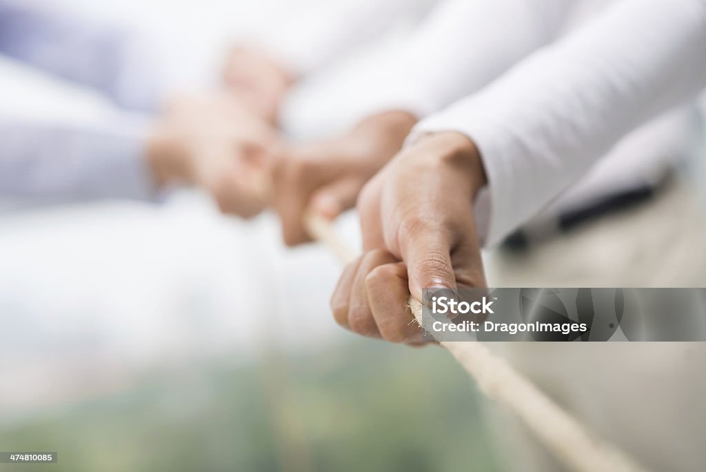 Team support Concept image of business team using a rope as an element of the teamwork on the foreground Rope Stock Photo