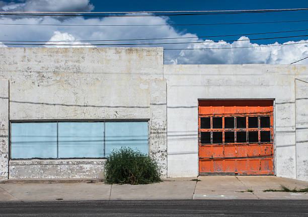 istock auto shop with orange garage door 474811928