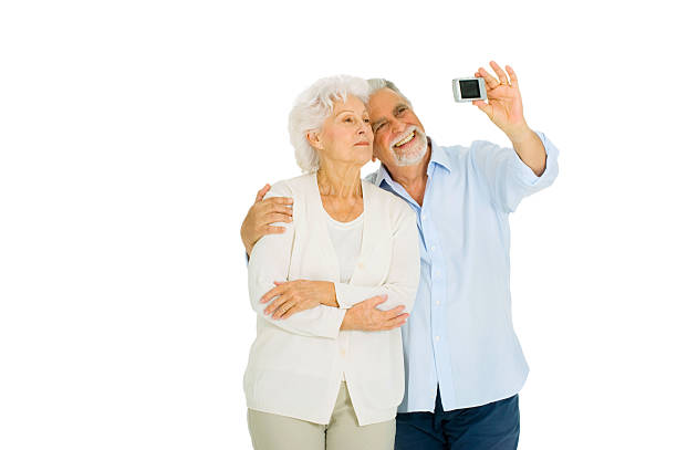 istock elderly couple taking photograph 474812090