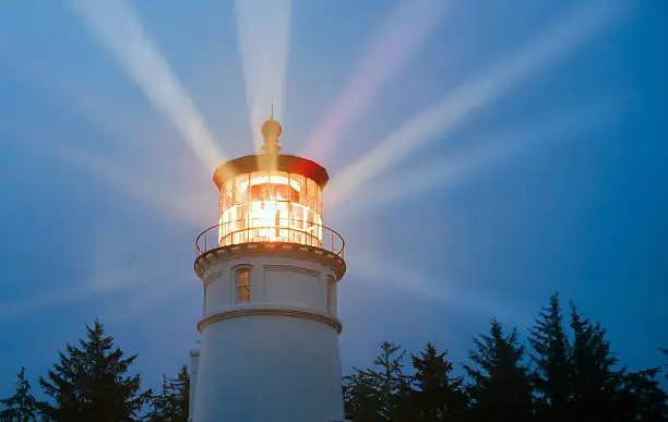 Photo of Lighthouse Beams Illumination Into Rain Storm Maritime Nautical Beacon