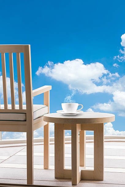 istock Wooden relax chairs and coffee cup with blue sky. 474815566