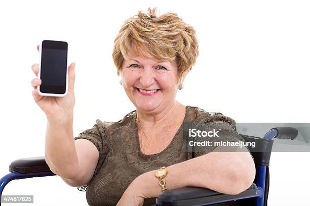 Elderly Woman In A Wheelchair Showing Smart Phone Stock Photo - Download Image Now - 70-79 Years, Active Seniors, Adult