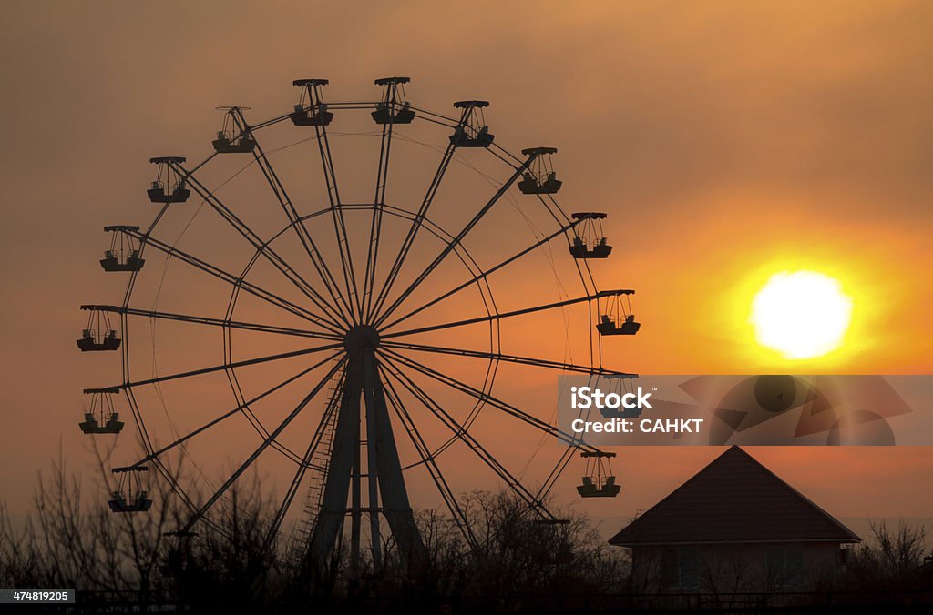 Ferris wheel Silhouette of ferris wheel at sunset Adulation Stock Photo