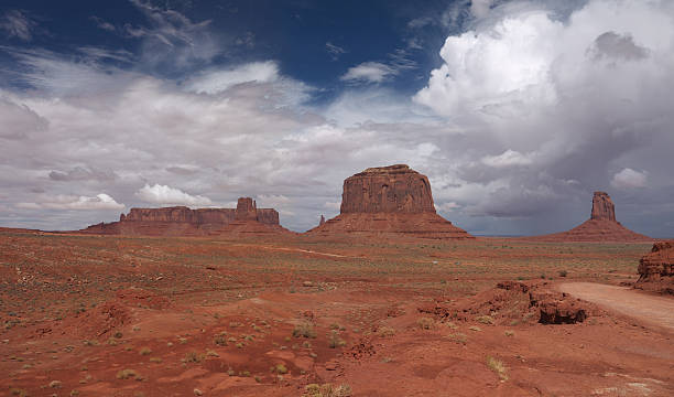 Merrick Butte in Monument Valley Loop Road in Monument Valley with Merrick Butte in forefground and nice clouds above merrick butte stock pictures, royalty-free photos & images
