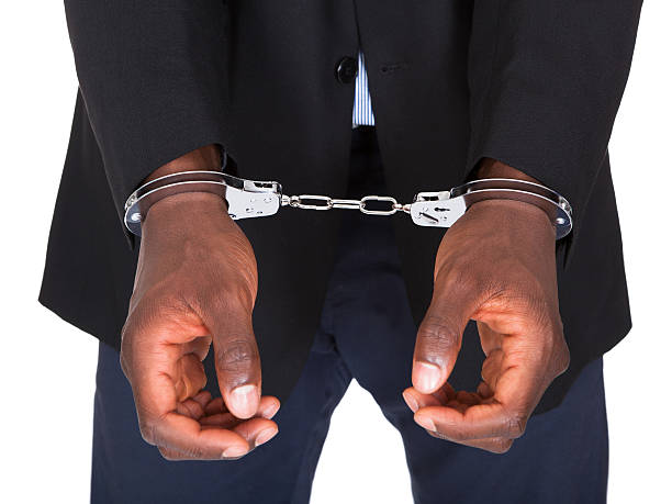 Arrested Man With Handcuffed Hands African Man With Handcuffed Hands Isolated On White Background detainee stock pictures, royalty-free photos & images
