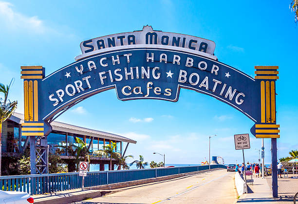 The welcoming arch of Santa Monica Pier Santa Monica, USA - September 23, 2014: The welcoming arch of Santa Monica Pier in Santa Monica, USA. The site is an iconic 100-year-old landmark for California visitors. santa monica stock pictures, royalty-free photos & images
