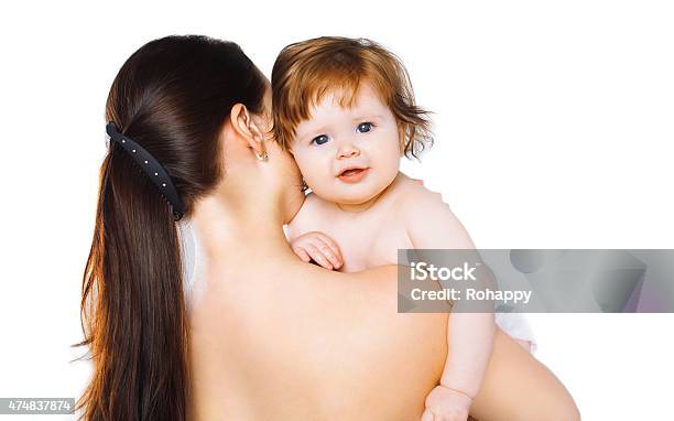 Mother Holding Cute Baby On A White Background Stock Photo - Download Image Now - 2015, Baby - Human Age, Beautiful People