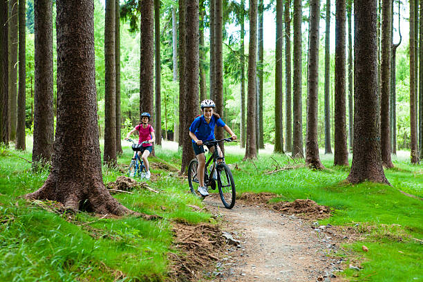 istock Two women riding bikes on forest trails 474839051