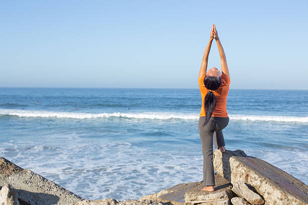 istock Caucasian woman practicing yoga at seashore 474842130