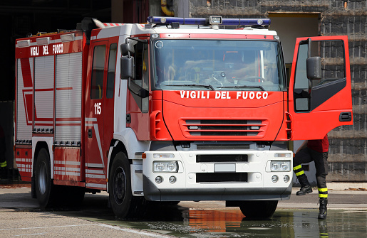 italian fire trucks with sirens blue and a fireman ready for emergency