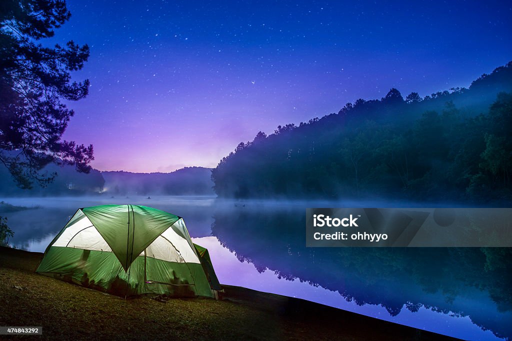 Small Camping Tent Illuminated Inside At Early Morning Light Photo - Download Image Now -