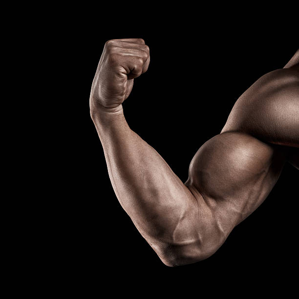 Close-up of athletic muscular hand Close-up of a power fitness man's hand. Strong and handsome young man with muscles and biceps. Studio shooting on black background. fist human hand punching power stock pictures, royalty-free photos & images