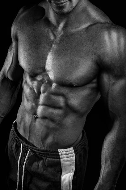 istock Strong athletic man fitness model showing torso muscles 474846704