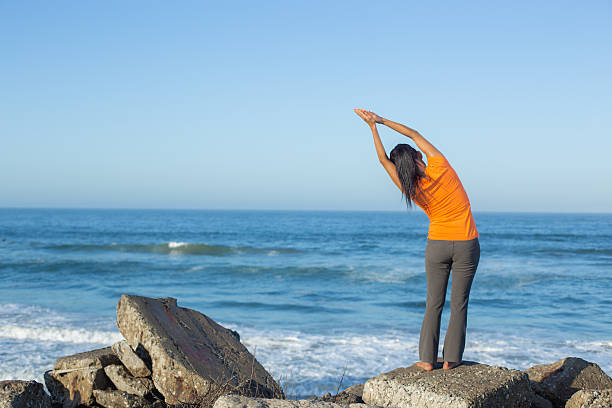 istock Caucasian woman practicing yoga at seashore 474846742